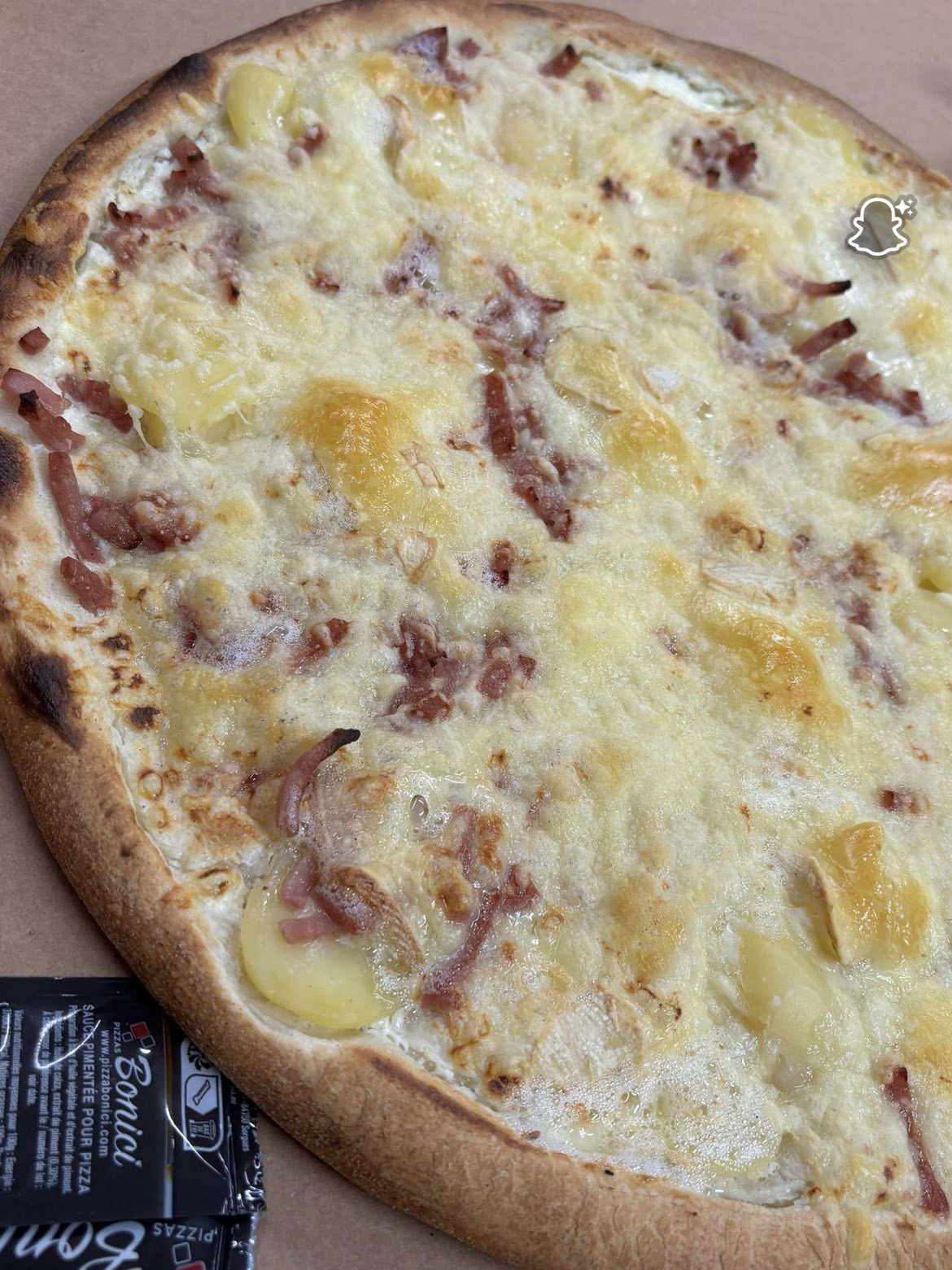 Pizza crème lardons tout juste sortie du four